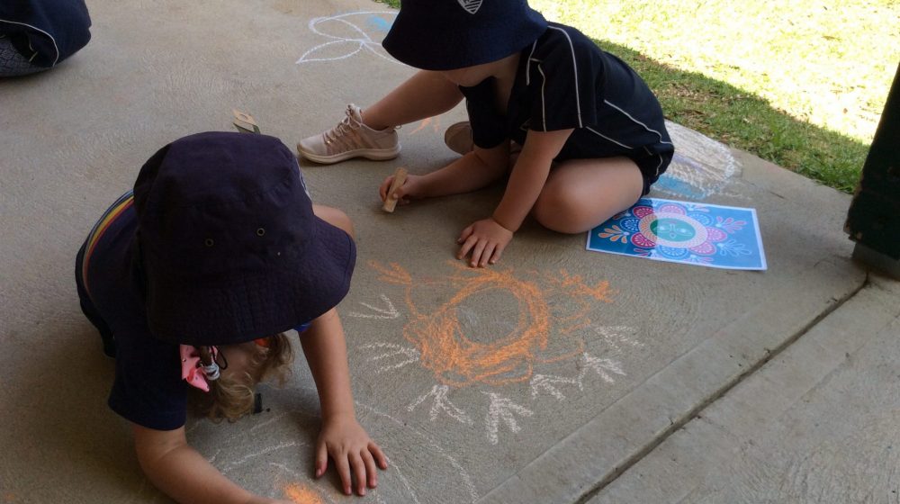 Children creating chalk art