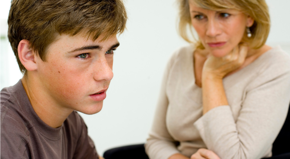 student with parent looking worried