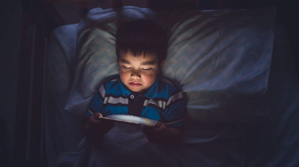 child on device at night