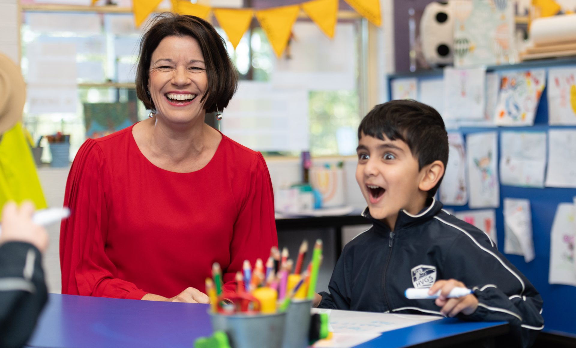 Teacher laughing with student