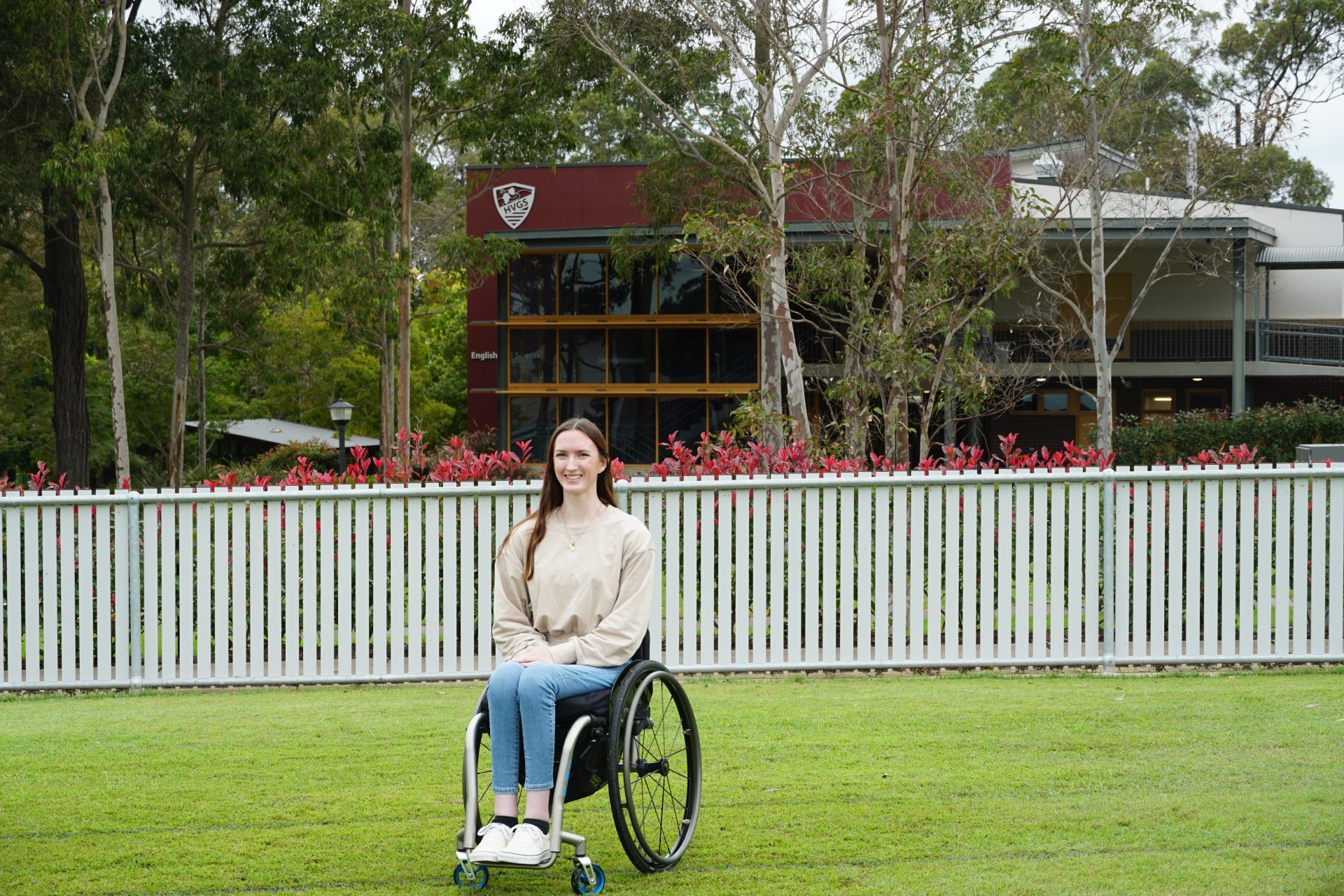 young woman in wheelchair on sports ova;